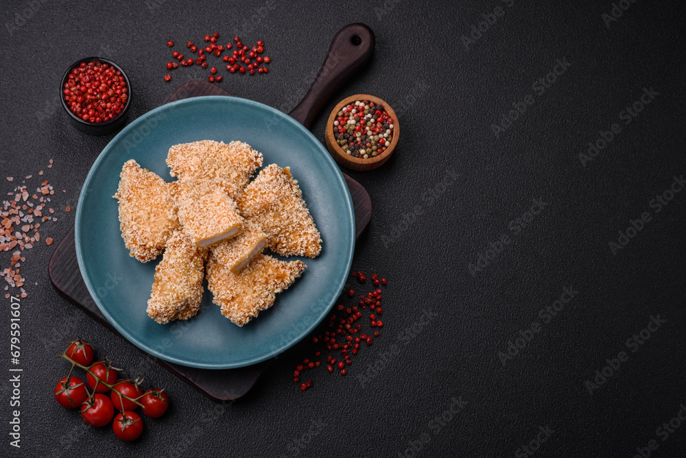 Delicious fresh crispy chicken nuggets on a dark concrete background
