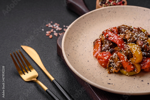 Warm salad with veal, tomatoes, peppers, zucchini, sesame, salt, spices and herbs