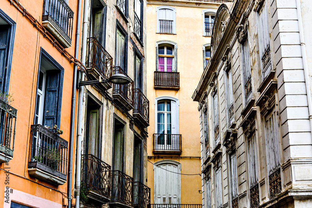 View of a street with typical buildings in Perpignan, France