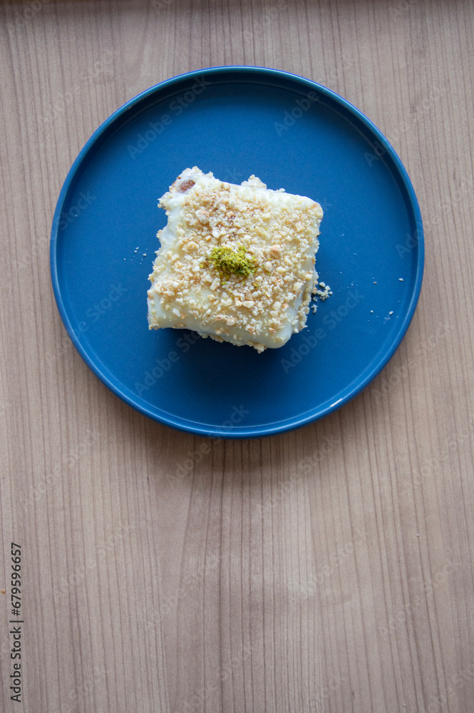 creamy dessert prepared for presentation on a blue plate creamy dessert prepared for presentation on a blue plate