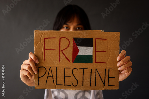Woman showing paperboard with text Free Palestine 