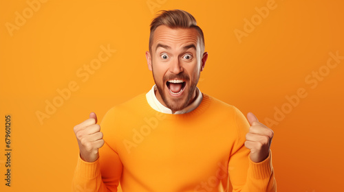 Man with excited expression on orange background © BB_Stock