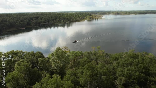 Motorboat Cruising On Crystal Lake In Polk County, Florida, USA. aerial sideways shot photo