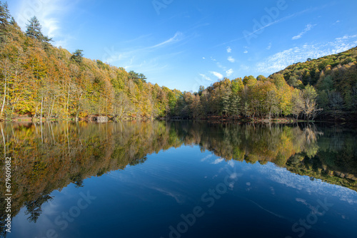Yedigöller or Seven Lakes National Park is in Turkey. Reflection of a lake with trees and blue sky in autumn colors. Yedigöller, Bolu. Yedigöller in autumn. Bolu, Türkiye.