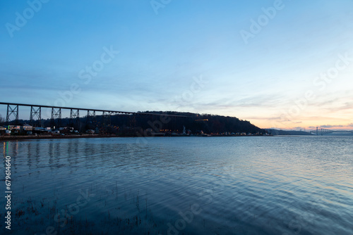 View of the 1908 railway trestle bridge and its reflection in the St. Lawrence River seen during a blue hour late fall sunrise  Quebec City  Quebec  Canada