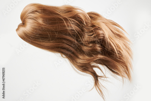 Natural looking shiny hair, brown curls isolated on white background with copy space