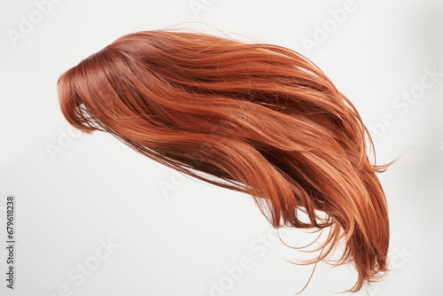 Natural looking shiny hair, red curls isolated on white background with copy space