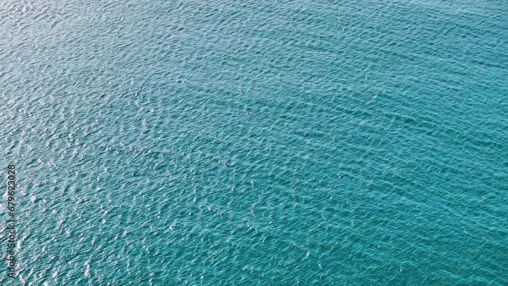Sun glare on a blue wavy background of sea water. Waves on the surface ...