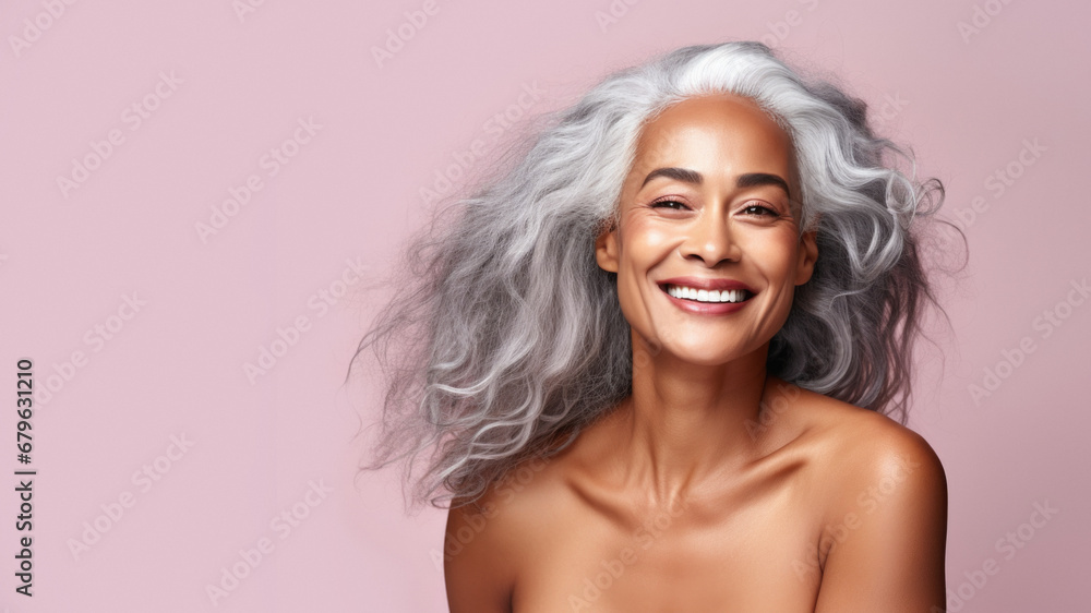 Portrait of an elegant mature woman with smooth healthy skin, long gray hair, and a joyful smile. Cosmetics and beauty advertising. Portrait of an elegant mature woman with smooth healthy skin, long gray hair, and a joyful smile. Cosmetics and beauty advertising.