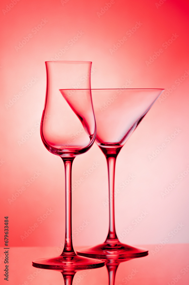 Empty glass wine glass on a red background..Wine glass for a drink on a red background. Dark silhouette of a glass. Empty glass wine glass on a red background..Wine glass for a drink on a red background. Dark silhouette of a glass.