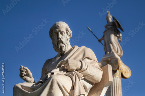 Marble statue of Greek philosopher Plato. Goddess Athena on background.