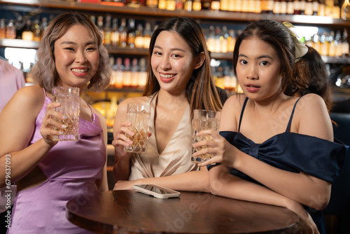 Portrait Group of Beautiful Asian Woman Enjoying with Friend in Bar. They Enjoying with Night Party Moment Together. Party, Lifestyle, Happiness, Cheerful and Celebration Concept.