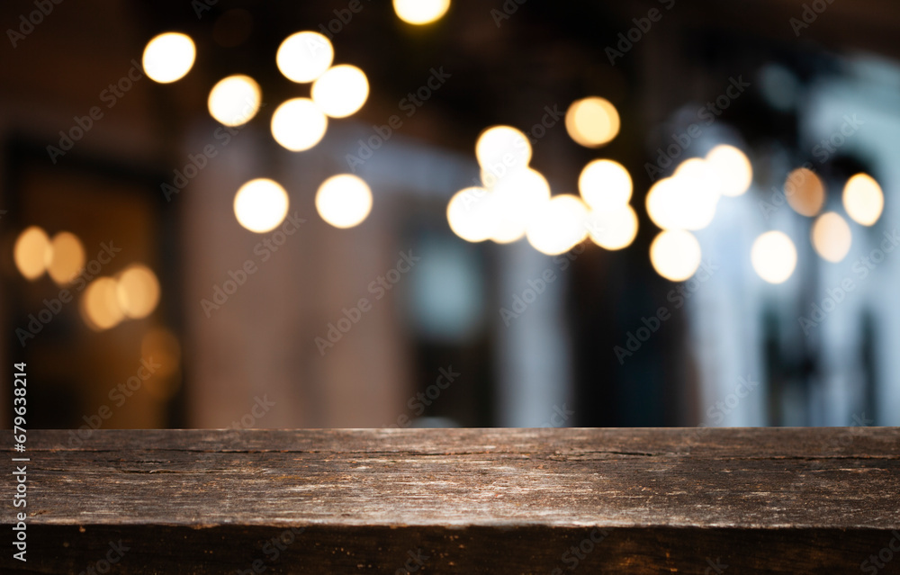 empty wooden table to showcase your product on blurred golden bokeh cafe background
