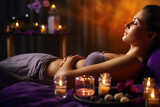 Young woman relaxing and enjoying in spa with candles, massage and aromatherapy