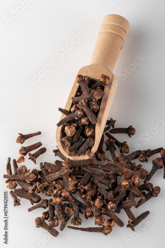 Clove tree buds lie in a wooden scoop..Aromatic cloves used for cooking. Cooking spice.