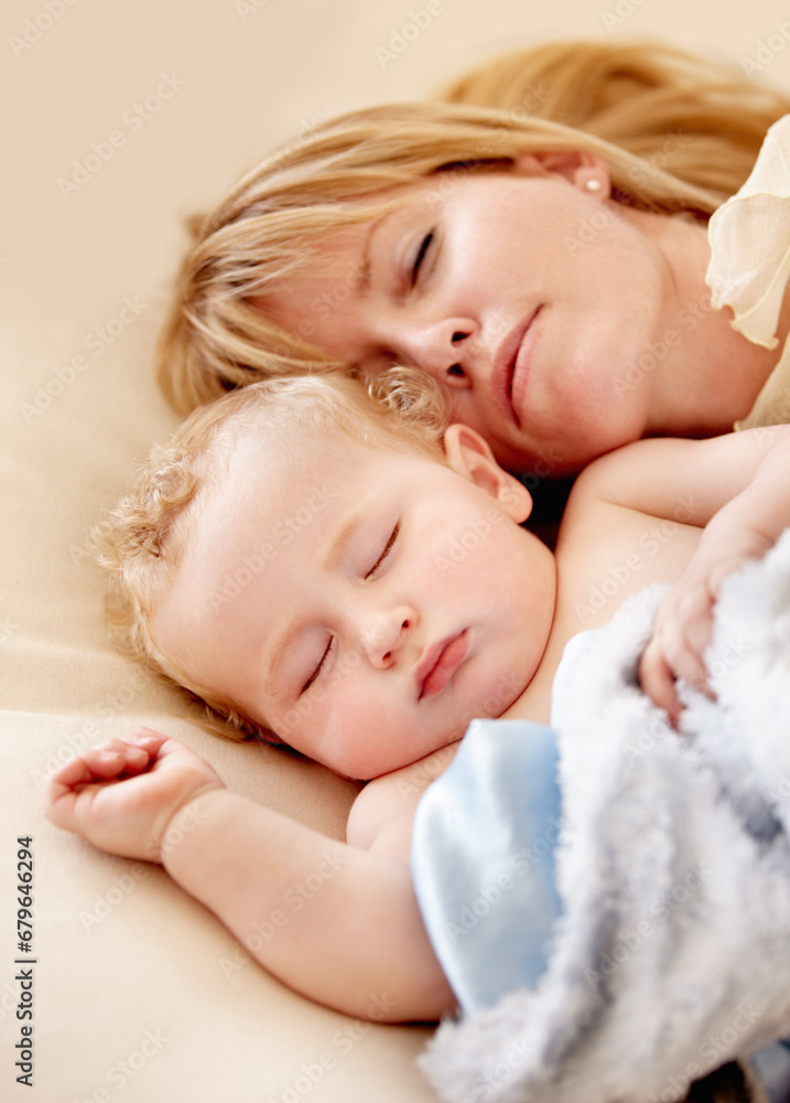 Sleeping, mom and baby with peace in bed together with calm moment with love for infant and kid in morning nap. Mother, cuddle and sleep with child in closeup and rest in bedroom or family home Sleeping, mom and baby with peace in bed together with calm moment with love for infant and kid in morning nap. Mother, cuddle and sleep with child in closeup and rest in bedroom or family home
