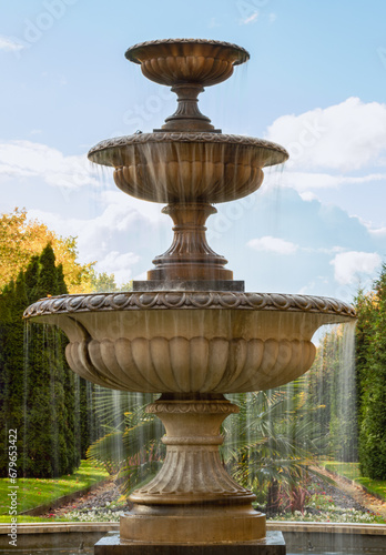 The three tiered water fountain statues in Regents park. which creates aesthetic atmosphere, Classic style stone fountain with flowing water, Vintage fountain, Copy space, Selective Focus.