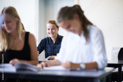 College student, portrait and learning with notes in class, lecture or people in education. University, classroom and face of happy woman with notebook, knowledge and studying in academy or school photo