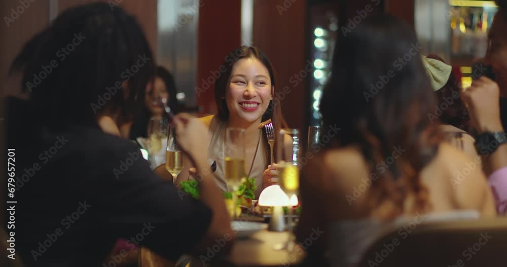 Beautiful Asian woman is Relishing a Delightful Dinner with Friends at a Bar, Immersed in the Joy of a Vibrant Night Party. They Enjoying with Night Party Together. Party and Celebration Concept. Beautiful Asian woman is Relishing a Delightful Dinner with Friends at a Bar, Immersed in the Joy of a Vibrant Night Party. They Enjoying with Night Party Together. Party and Celebration Concept.