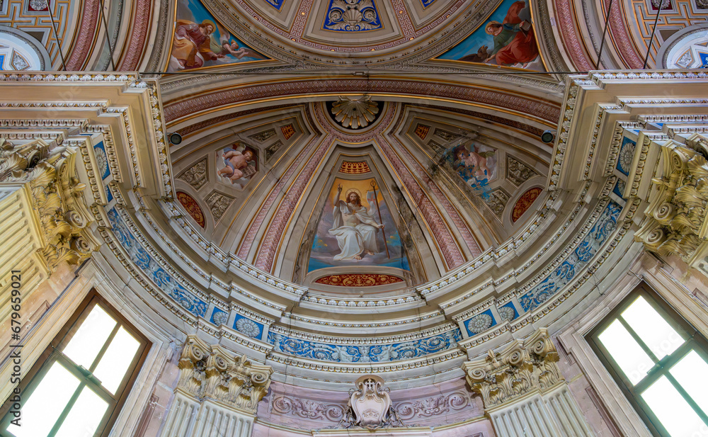 Detail of amazing decorating dome ceiling and walls inside catholic cathedral in Italy