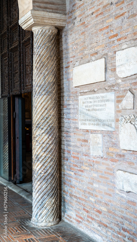 Side view of museum entrance in Italy decorated with ancient roman pillar and marble signs written in latin