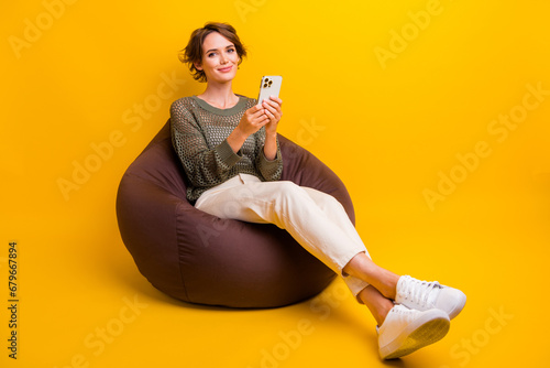 Canvastavla Photo of lovely cute girl sitting comfy pouf enjoy relax rest read instagram tel