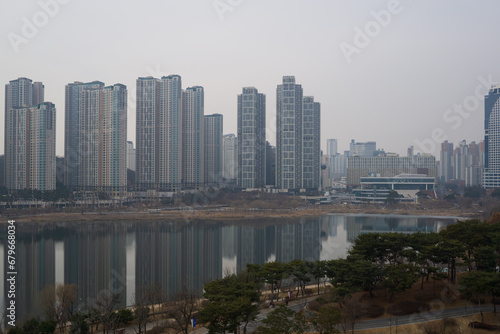 luxury apartment residential next to lake park at foggy day