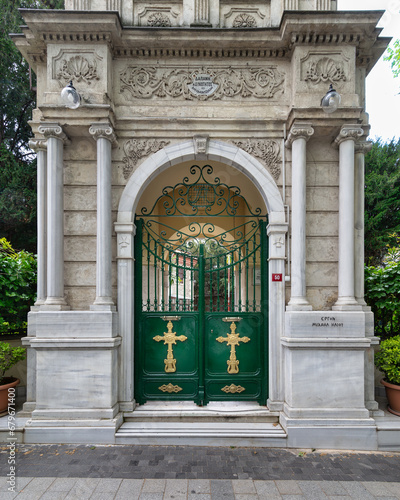 Green Gate with Gold Crosses framed by elegant marble decorations, at the Entrance of Agios Greek Orthodox Panteleimonas Church, located in Kuzguncuk neighborhood, Uskudar, Istanbul, Turkey photo
