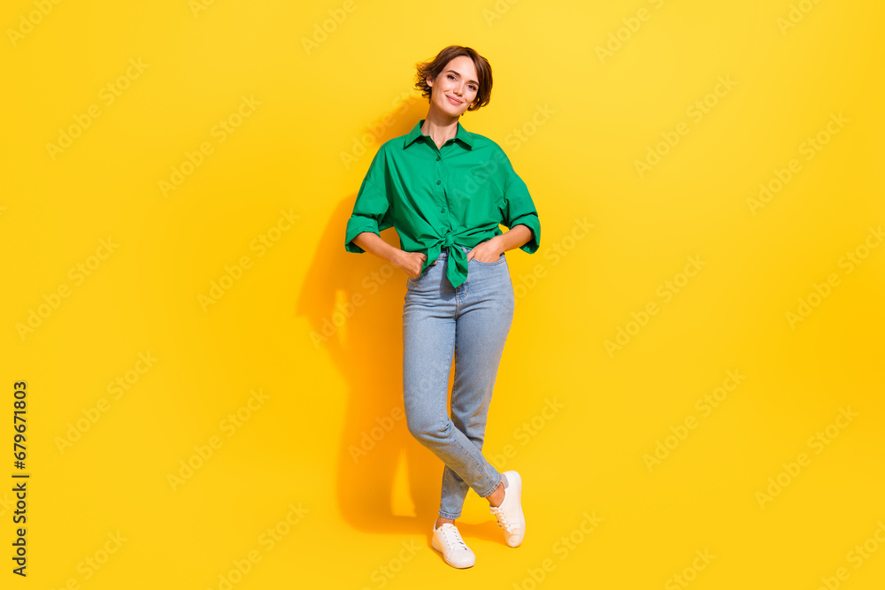 Full length photo of shiny good mood lady wear green shirt smiling walking isolated yellow color background Full length photo of shiny good mood lady wear green shirt smiling walking isolated yellow color background