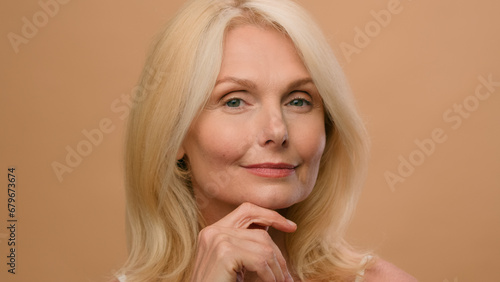 Portrait beautiful old woman perfect face mature Caucasian senior middle age female in beige studio ads of anti-aging lifting skincare hydration plastic surgery anti-wrinkle beauty cosmetics product