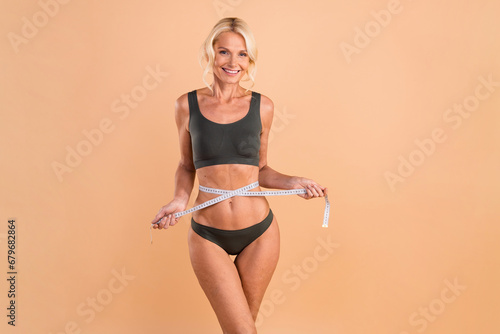 Photo of retired nutrition coach measure belly with centimeter isolated on pastel color background