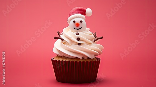  a cupcake with white frosting and a red santa hat on top of the cupcake on a pink background.