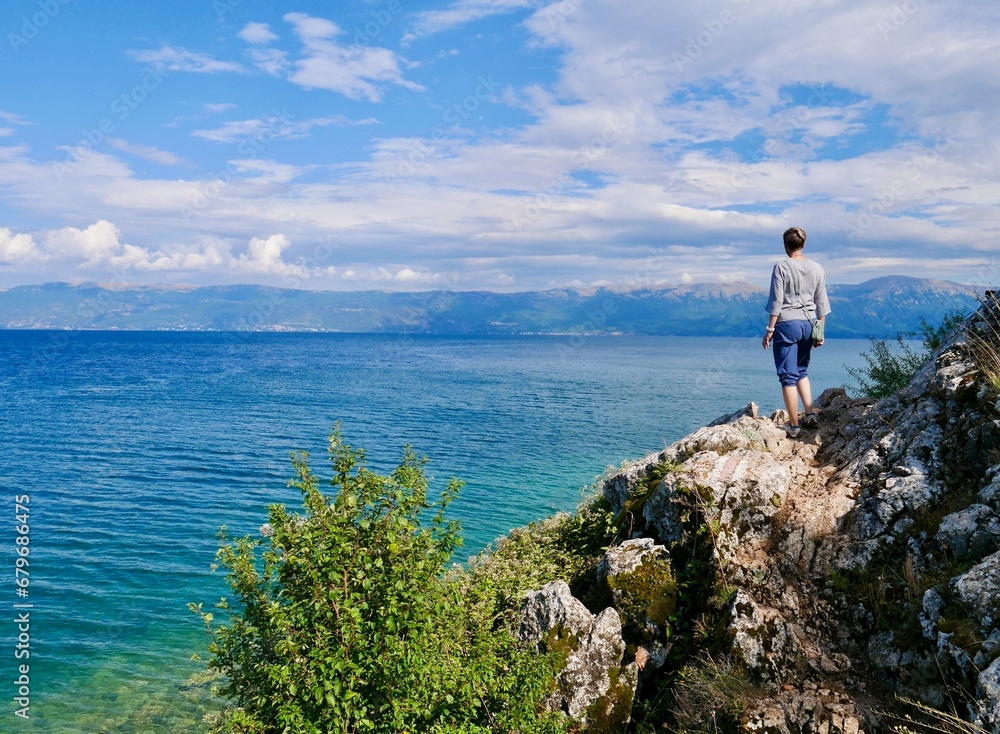 Woman looking looking at Lake Ohrid, Lin, Albania.