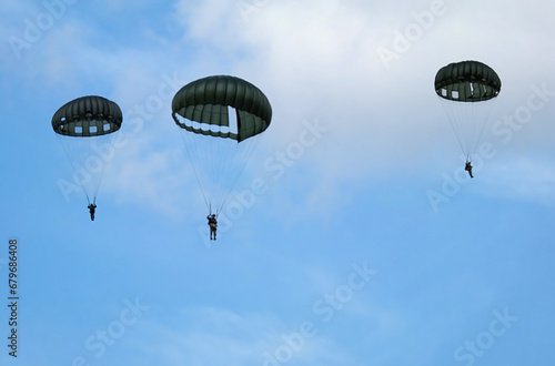 Victory Show. Leicester, UK. Renacted parachute jump with round military style parchutes.  photo