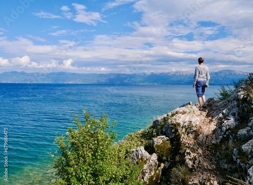 Woman looking looking at Lake Ohrid, Lin, Albania.