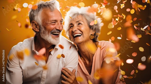  a man and a woman are smiling and confetti is falling in the air in front of the camera.