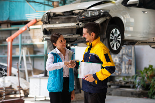 Insurance claim Inspector Inspect damage car caused by car crash on the road with customer. Car insurance agent examining car in garage. Motor insurance. Successful businessmen handshaking good deal