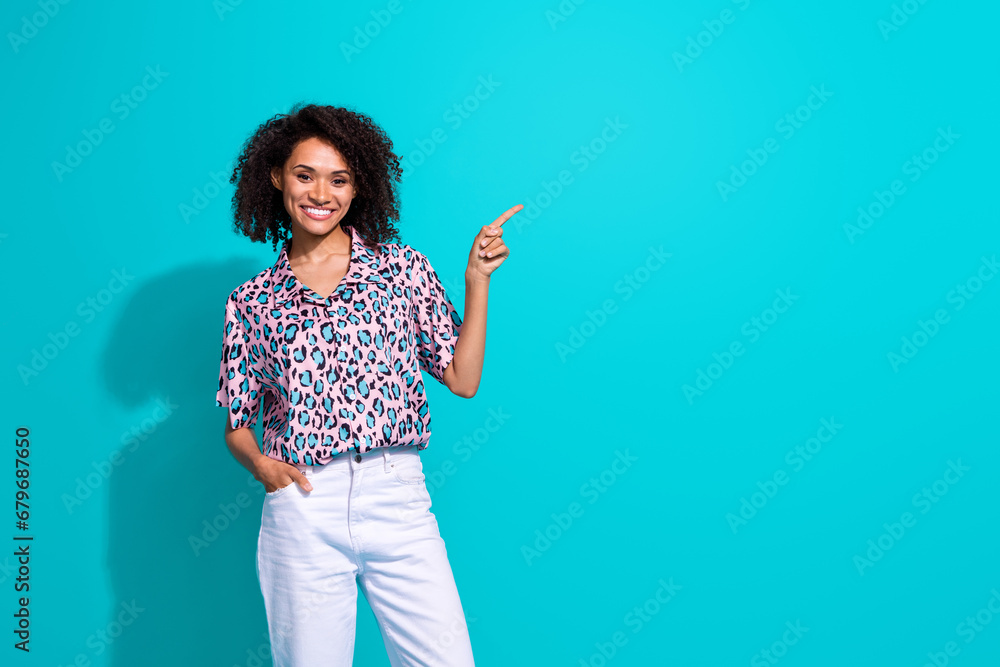 Photo of lovely cute satisfied girl wear trendy outfit arm demonstrate empty space nice feedback banner isolated on cyan color background Photo of lovely cute satisfied girl wear trendy outfit arm demonstrate empty space nice feedback banner isolated on cyan color background