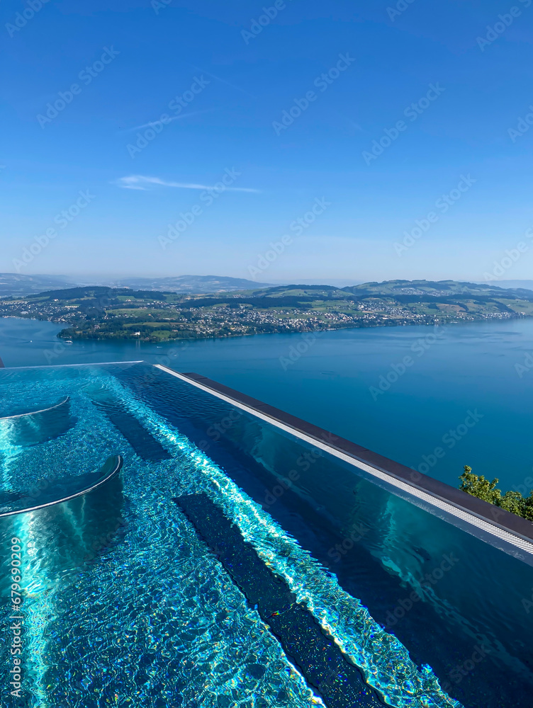 Infinity Swimming Pool with Mountain and Lake Lucerne  View in a Sunny Day in Lucerne, Switzerland.