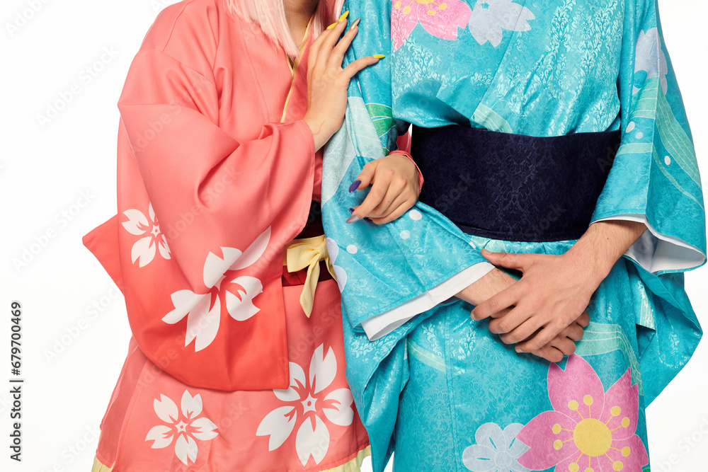cropped view of anime couple in bright and elegant kimonos on white, japanese cosplay subculture