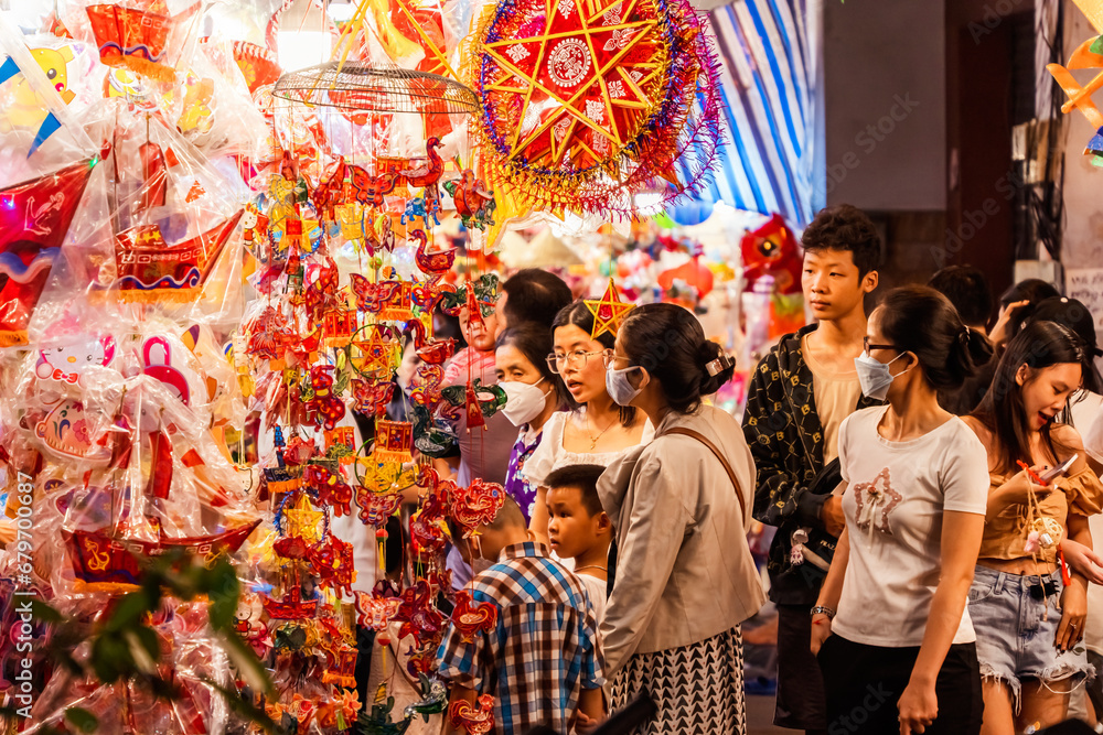 People visit and buy colorful traditional lanterns hanging on Luong Nhu Hoc Street in Vietnam People visit and buy colorful traditional lanterns hanging on Luong Nhu Hoc Street in Vietnam