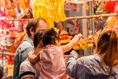 People visit and buy colorful traditional lanterns hanging on Luong Nhu Hoc Street in Vietnam