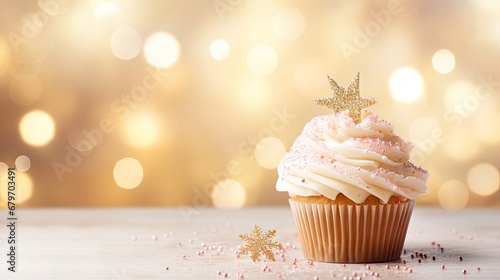  a cupcake with white frosting and sprinkles on a table with a gold star on top.