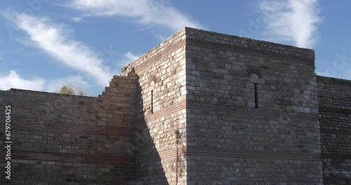 Wallpaper Mural An ancient stone fortress wall and an observation tower with loopholes against the blue sky. Historical restoration. Torontodigital.ca