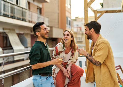 woman man rooftop friend youth young party friendship talking fun happy outdoor group drink lifestyle summer together terrace leisure photo