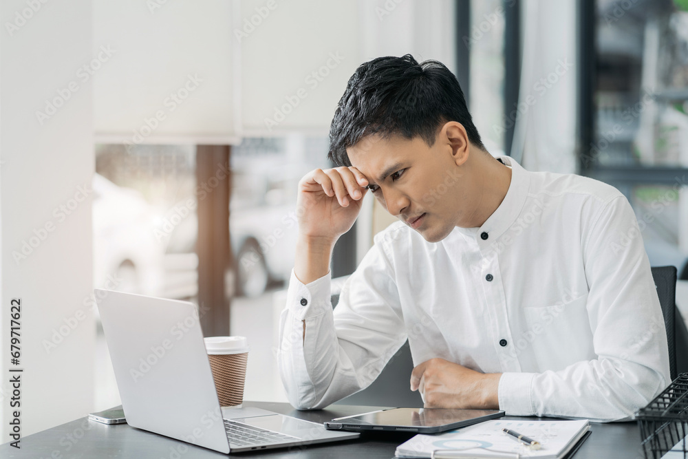 Stress businessman is sitting at table, under stress from working. Stress businessman is sitting at table, under stress from working.