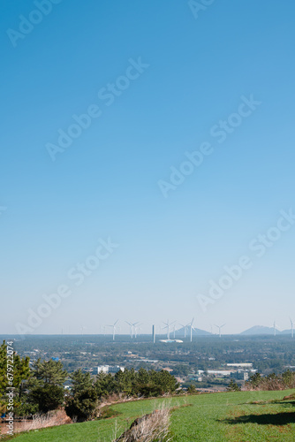 Wind power generator and forest view from Seoubong peak in Jeju Island, Korea photo