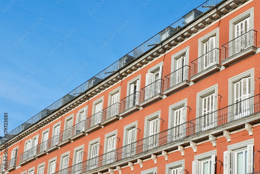 Colourful facade with many windows with shutters downtown Madrid, Spain. Classical Spanish architecture