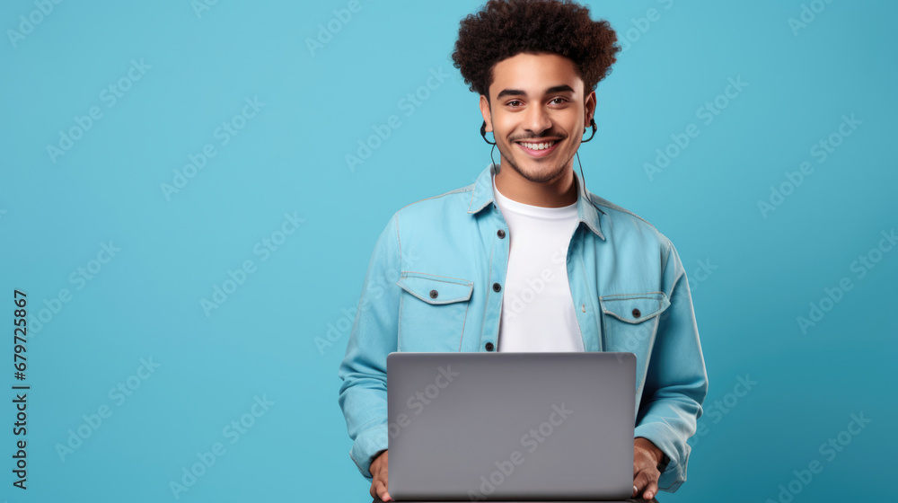 Smiling cheerful smart manwearing casual teenage clothes using laptop computer pose looking at camera isolated color background Smiling cheerful smart manwearing casual teenage clothes using laptop computer pose looking at camera isolated color background