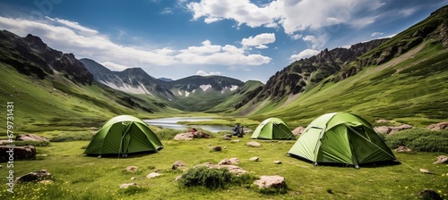 Tourist camp in the majestic mountains colorful tent in the foreground under the midday sun © Ilja